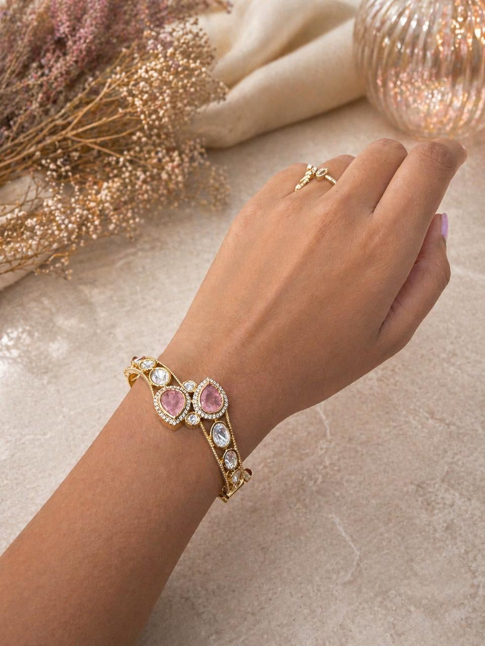 Gold bracelet with pink teardrop stones and round crystal detailing