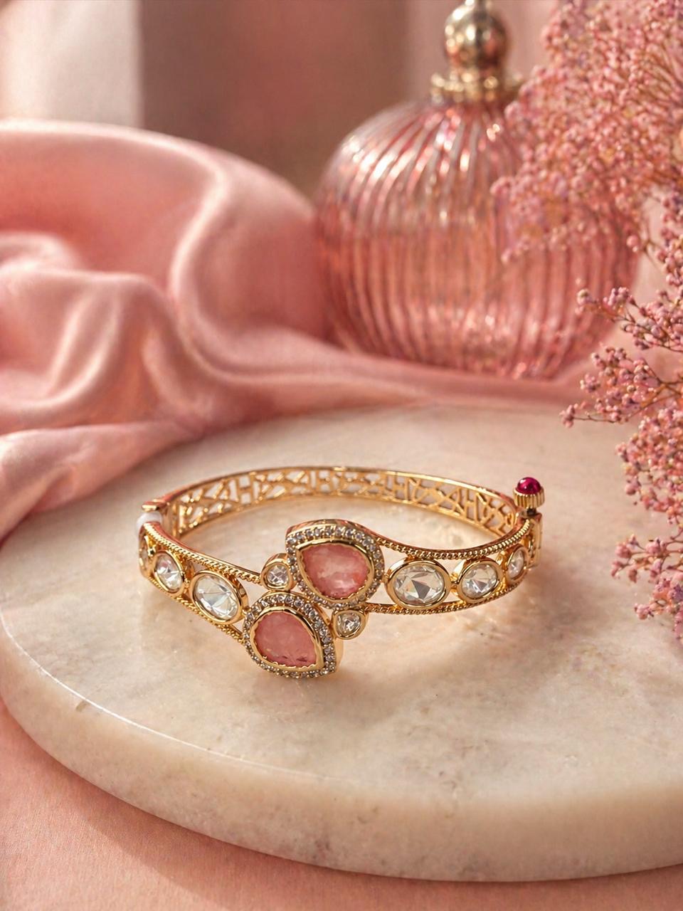 Gold bracelet with pink teardrop stones and round crystal detailing