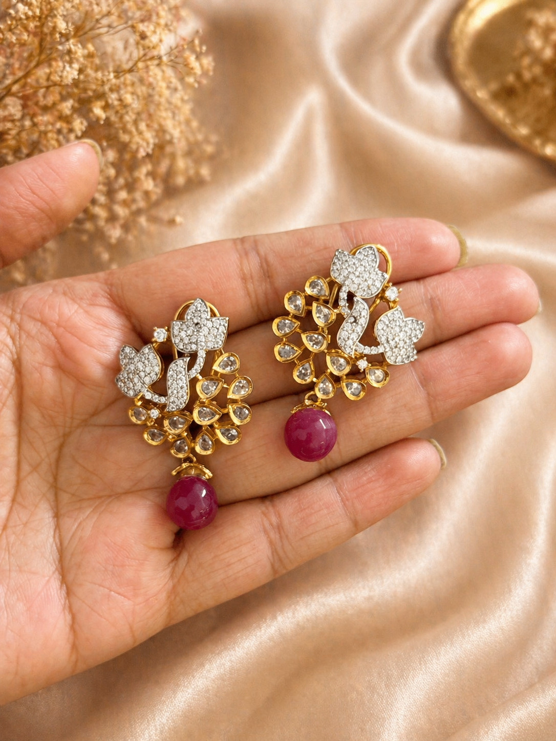 Gold plated floral kundan earrings with red bead drop design
