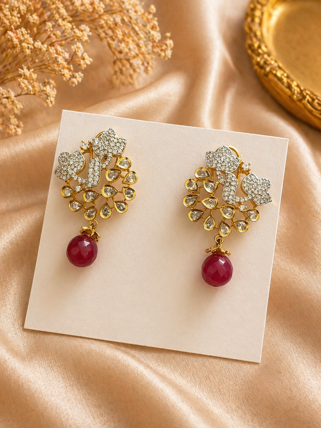 Gold plated floral kundan earrings with red bead drop design