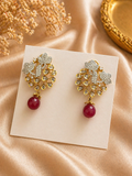 Gold plated floral kundan earrings with red bead drop design