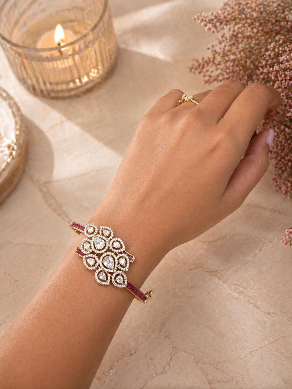 Gold floral bracelet with polki stones and ruby accents in a statement design