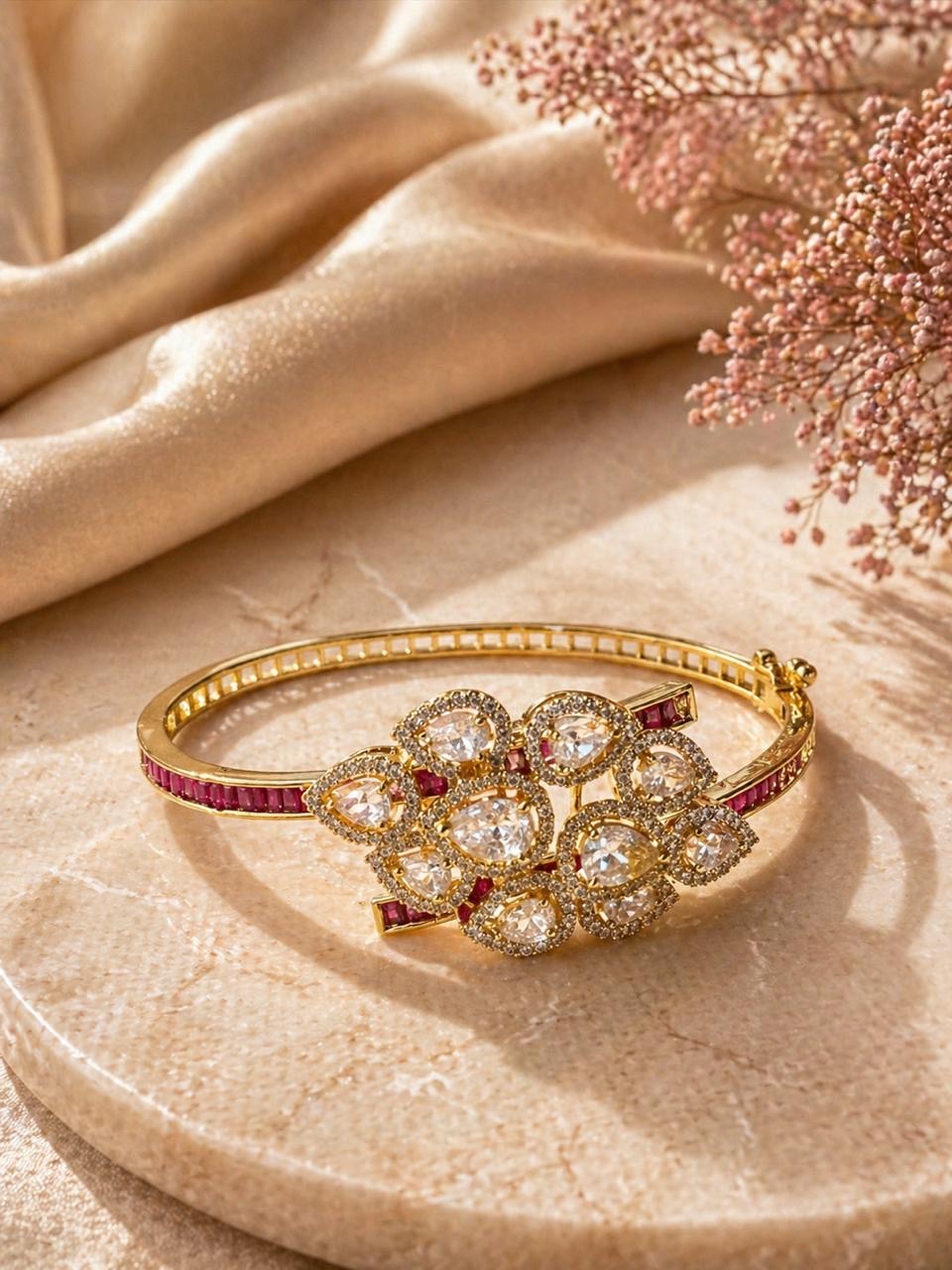 Gold floral bracelet with polki stones and ruby accents in a statement design