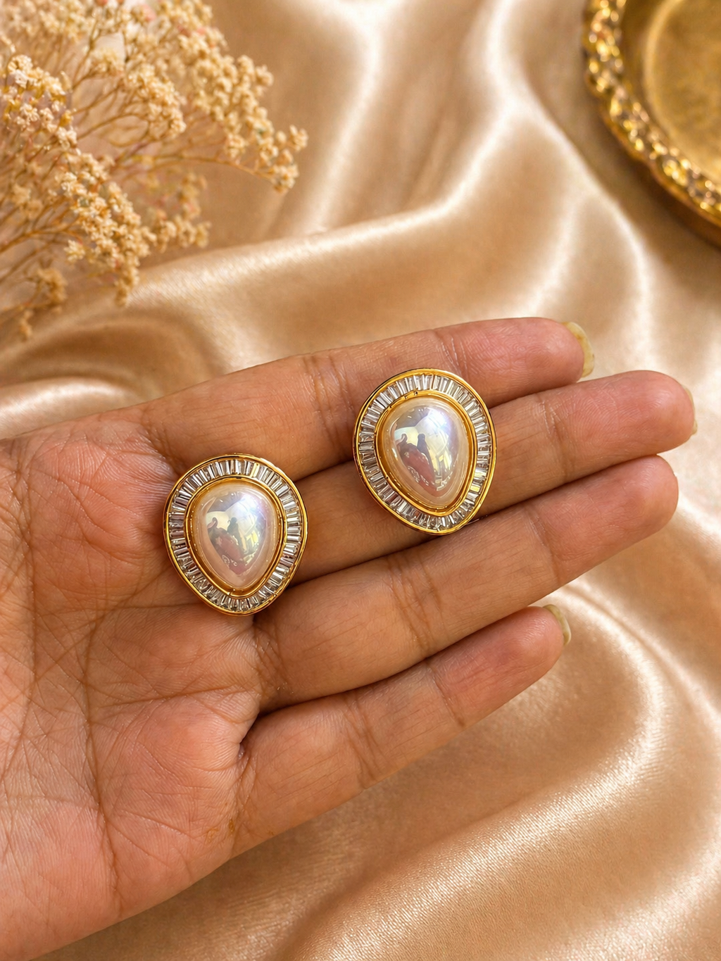 Gold plated oval pearl stud earrings with baguette stone halo