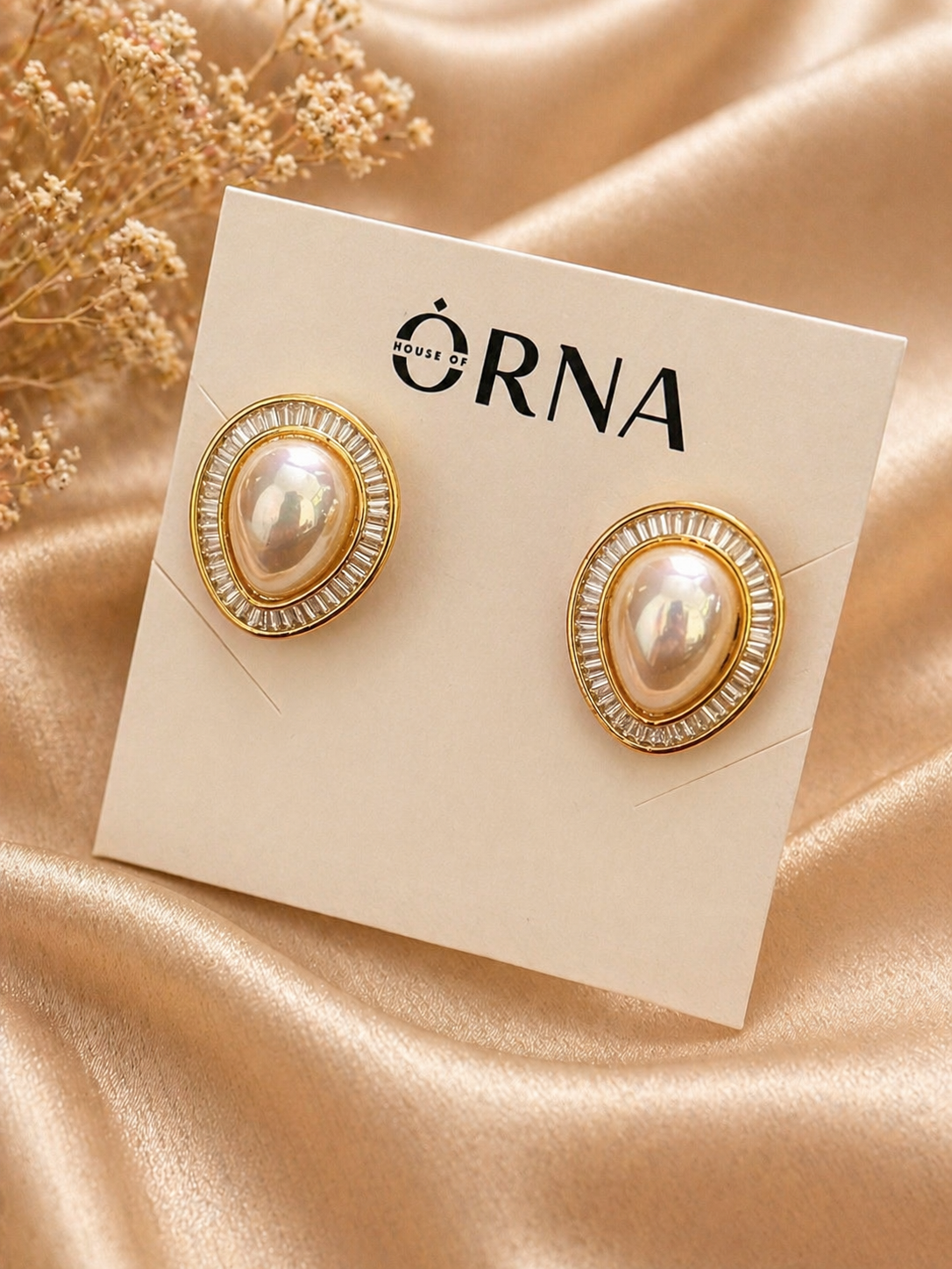 Gold plated oval pearl stud earrings with baguette stone halo