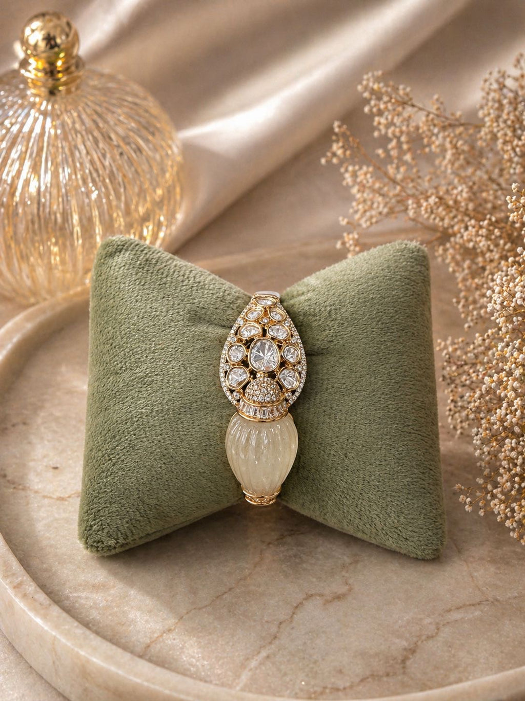 Gold statement kada bracelet with polki stones and carved centerpiece design