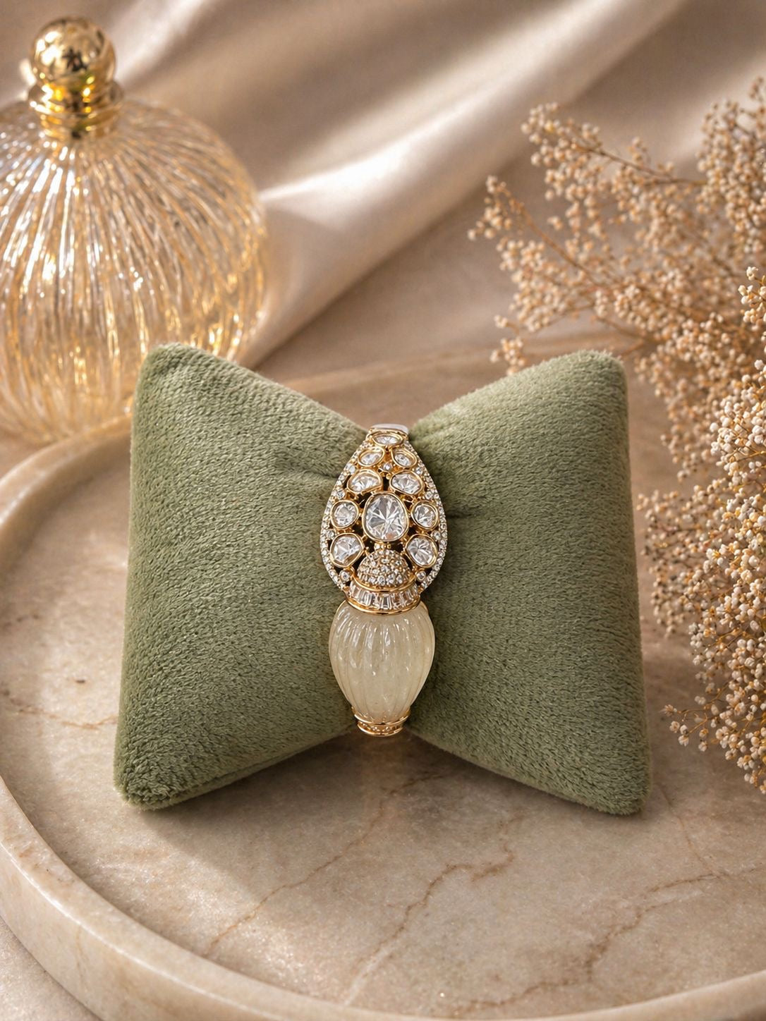Gold statement kada bracelet with polki stones and carved centerpiece design