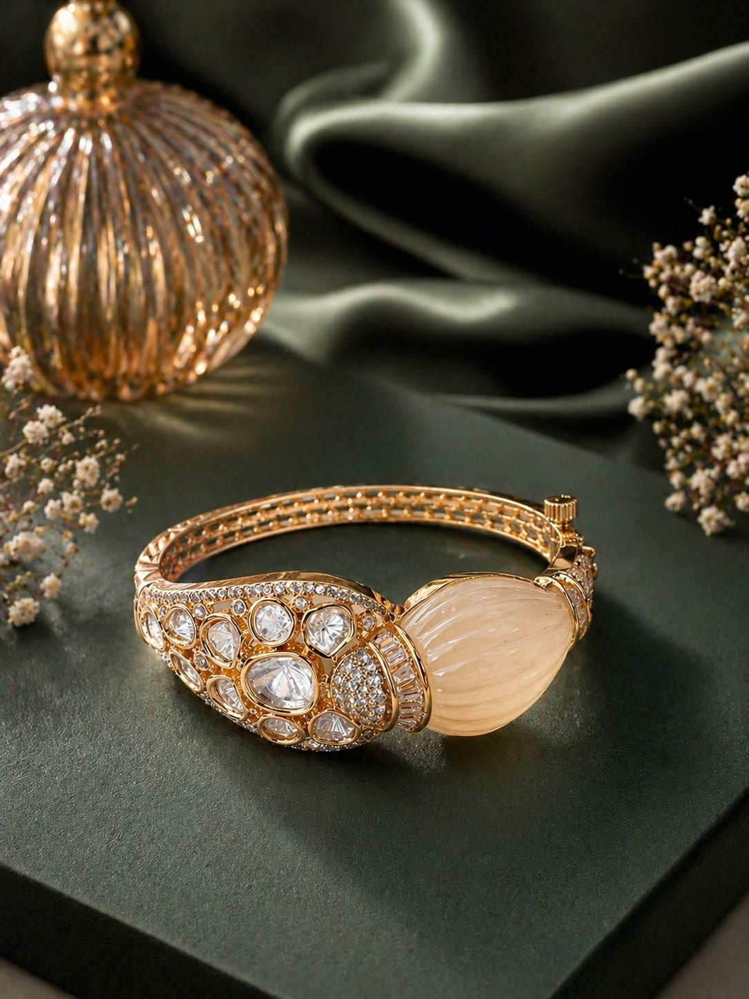 Gold statement kada bracelet with polki stones and carved centerpiece design
