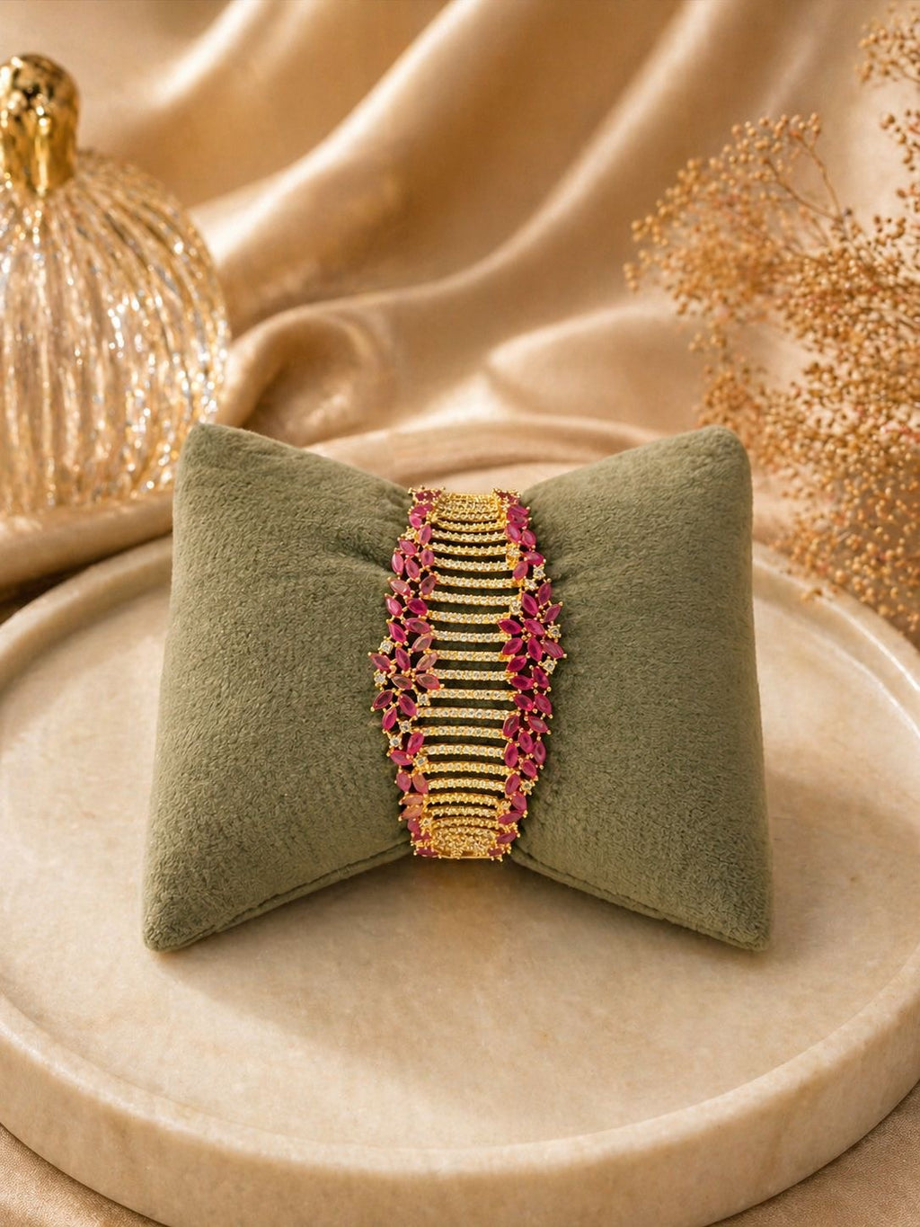 Gold statement bracelet with ruby stones and crystal detailing in a bold design