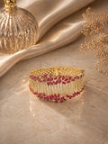 Gold statement bracelet with ruby stones and crystal detailing in a bold design