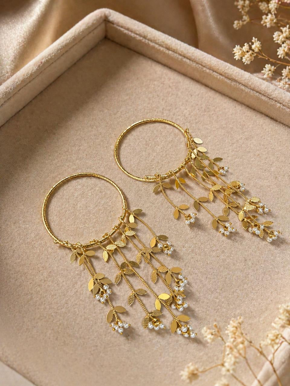 Gold statement hoop earrings with pearl drops and leaf tassel chains