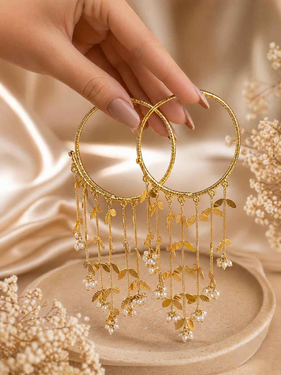 Gold statement hoop earrings with pearl drops and leaf tassel chains