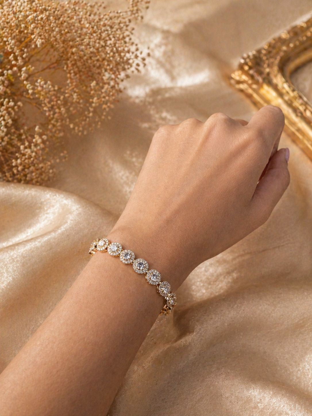 Gold tennis bracelet with round crystal stones and adjustable chain clasp