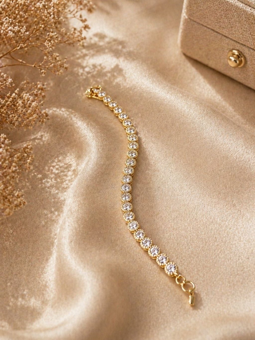 Gold tennis bracelet with round crystal stones and adjustable chain clasp