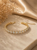 Gold tennis bracelet with round crystal stones and adjustable chain clasp