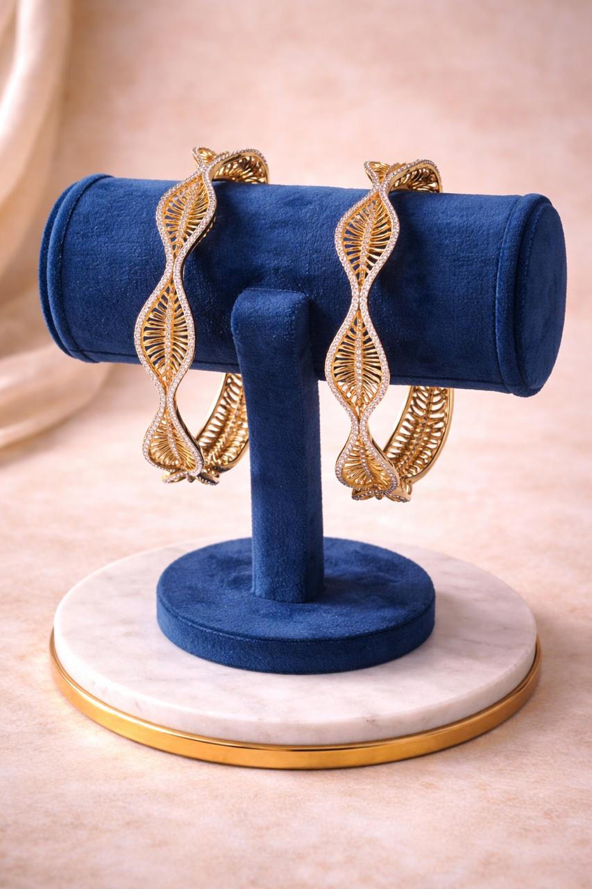 Real gold finish diamond look leaf design bangles set with wave pattern for festive and wedding wear
