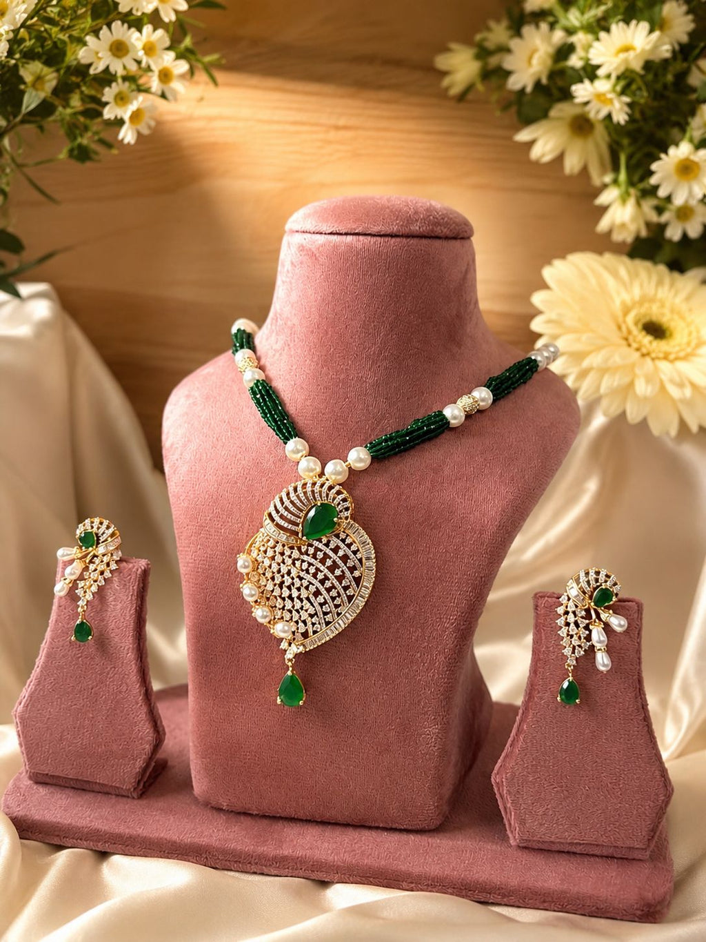 green stone pearl pendant necklace set with matching earrings displayed on pink stand