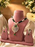 green stone pearl pendant necklace set with matching earrings displayed on pink stand