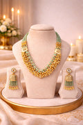 Real gold finish temple necklace set with mint green beads and traditional design for wedding and festive wear