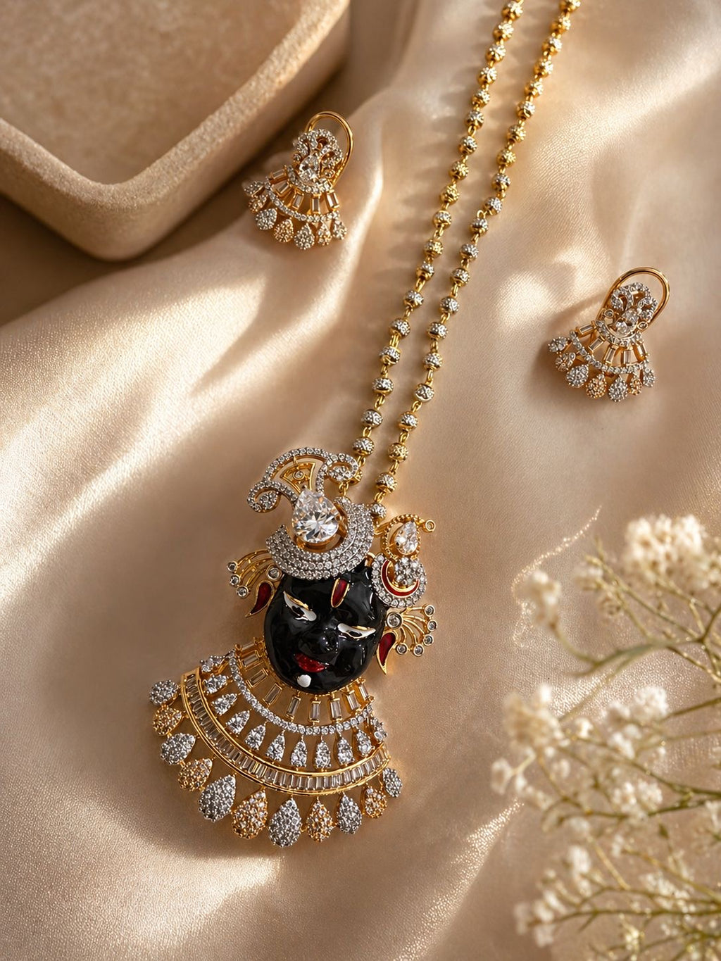 gold plated krishna motif pendant necklace set with cz stones and matching earrings