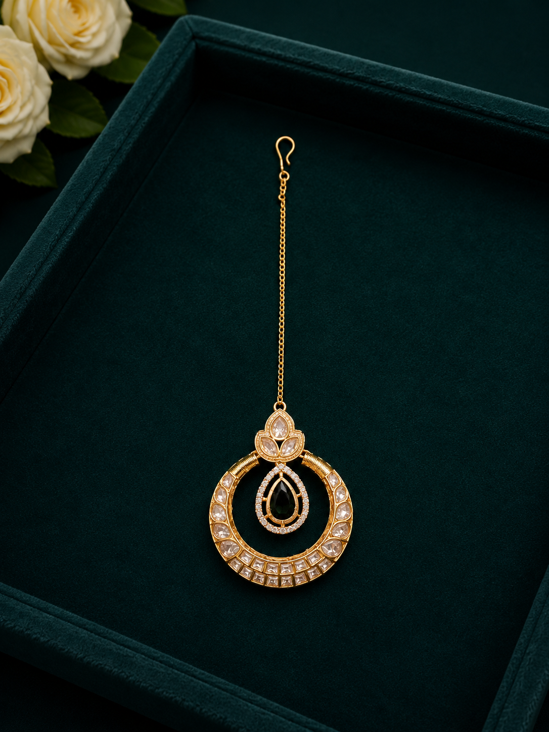 kundan circular maang tikka with emerald green drop stone on velvet tray