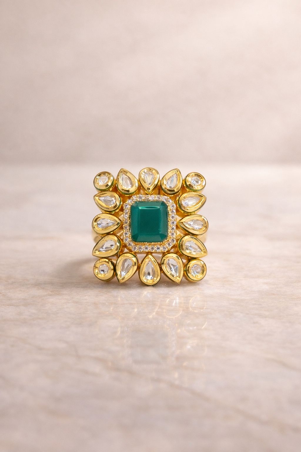 Emerald green statement ring with halo design for festive and wedding wear