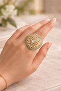 Intricate circular statement ring with detailed design worn on hand for festive and traditional wear