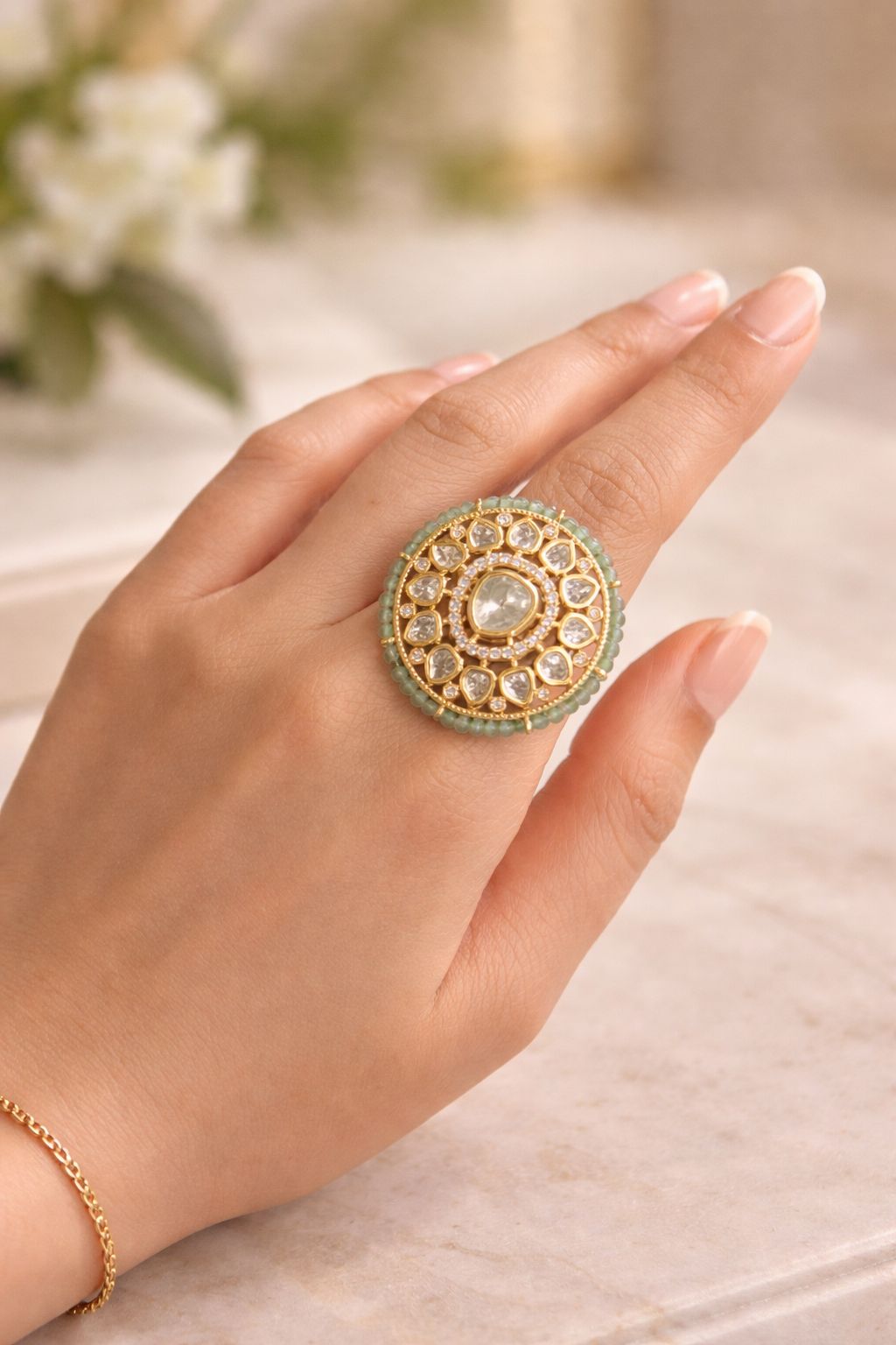 Intricate circular statement ring with detailed design worn on hand for festive and traditional wear