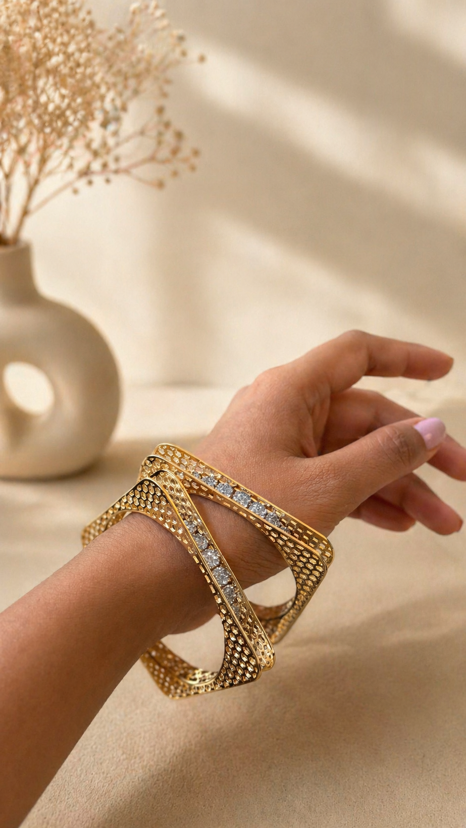 Modern mesh design statement bangles set worn on hand with crystal detailing for festive and evening wear