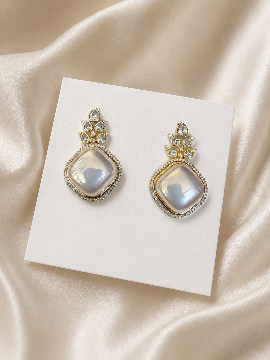 Opal stone statement drop earrings worn on hand with crystal detailing for festive and elegant wear