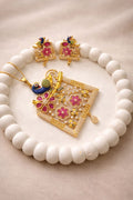 Gold finish peacock pendant set with floral design for festive and traditional wear