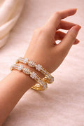 Real gold finish diamond look floral bangles set worn on hand for wedding and festive wear