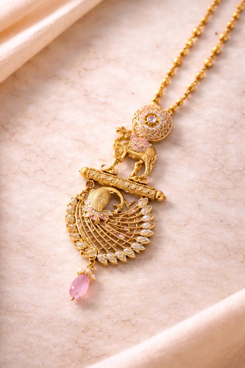 Gold finish peacock pendant set with pink stone drop for festive and traditional wear