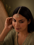 woman wearing ruby pearl bridal maang tikka with kundan detailing