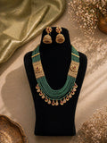 Temple style green beaded necklace set with red stone drops for wedding and festive wear