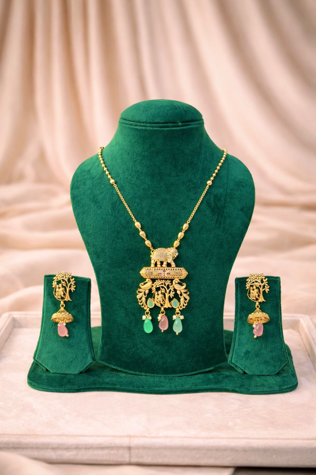 Real gold finish temple necklace set with intricate design and pastel stone drops for wedding and festive wear